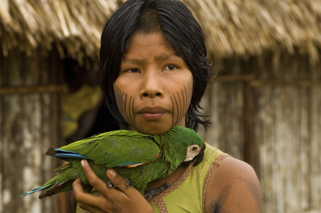 Kayapo girl with parrot/Photo by Cristina Mittermeier
